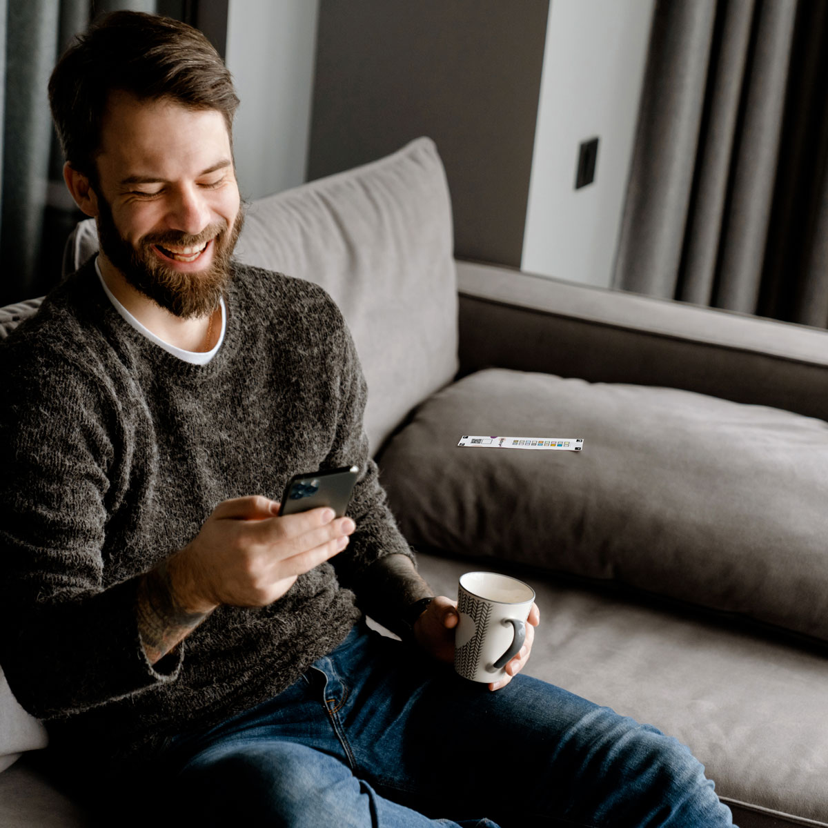 man use Biostrip NutraLife on sofa